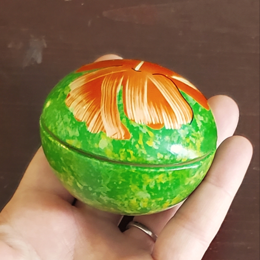Small wooden hand painted trinket box. Round with flat bottom for easy standing.